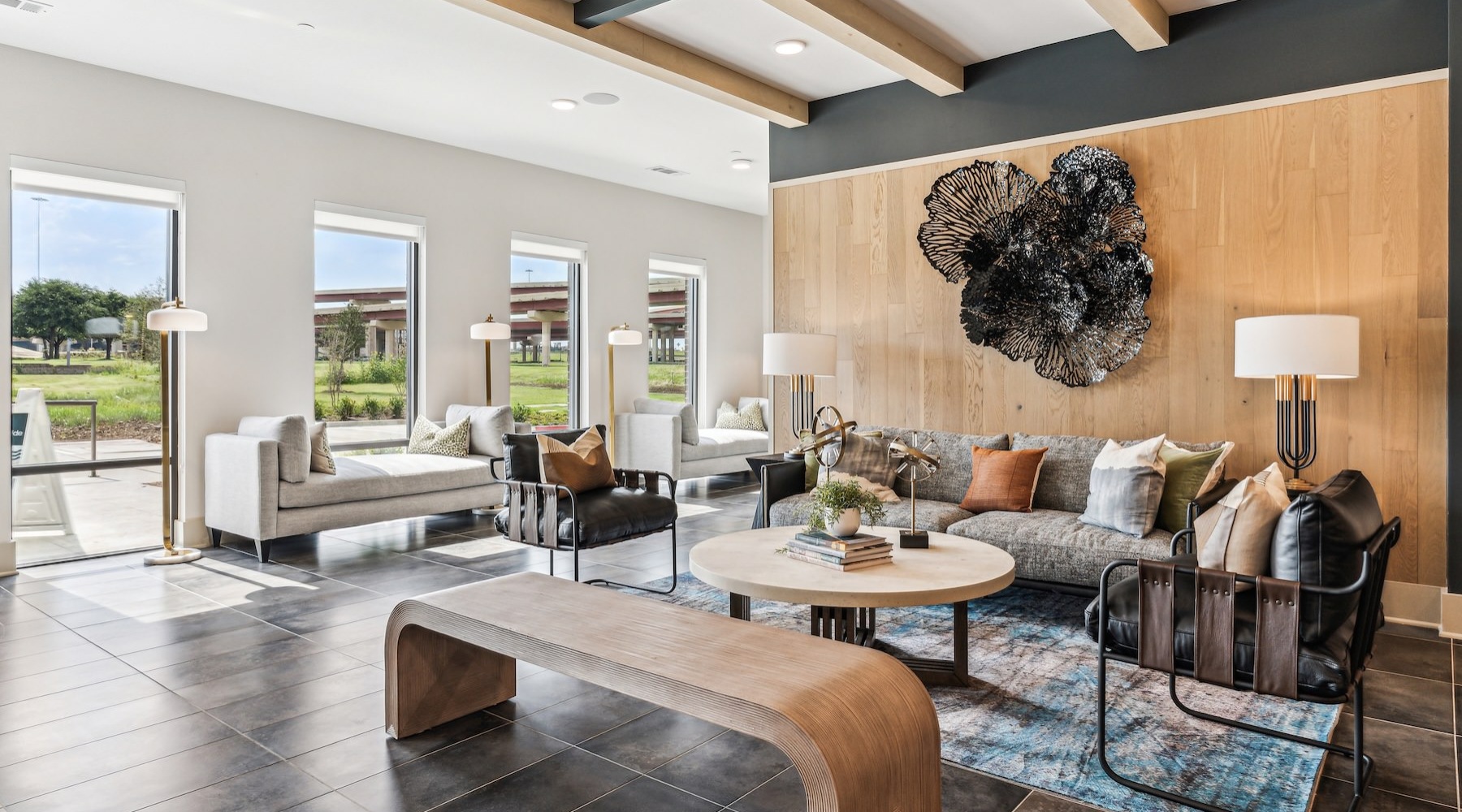 a lounge with a couch, tables and chairs