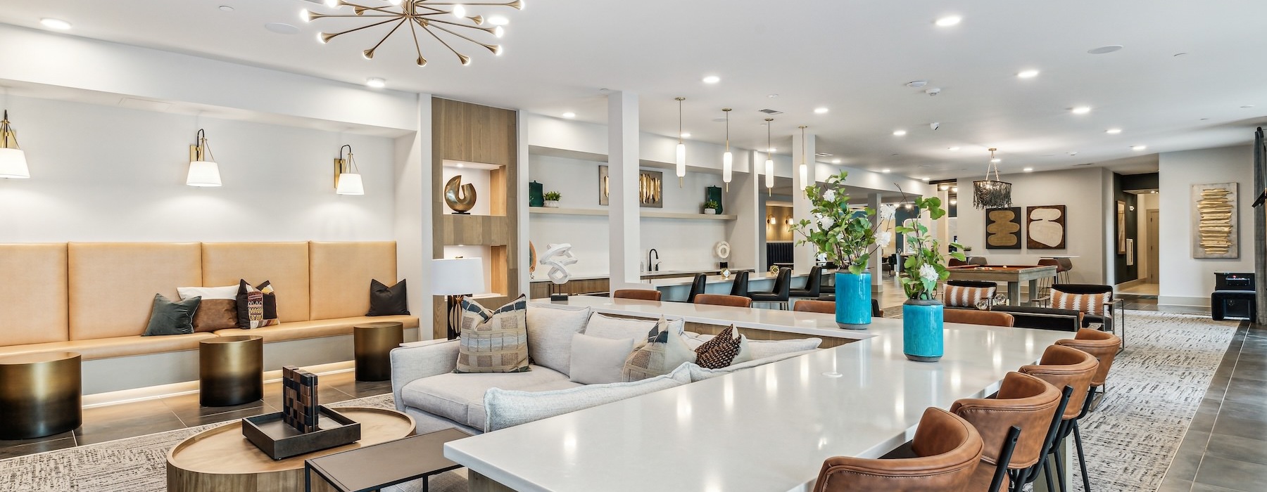 a clubroom with a couch, tables and chairs
