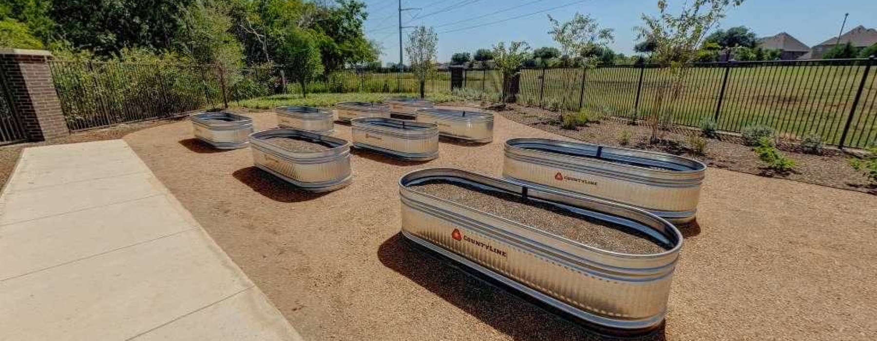 metal containers in a raised garden